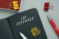 Business concept about CUT EXPENSES with inscription on the page. Cost cuttingÃÂ refers to measures implemented by a company toÃÂ 